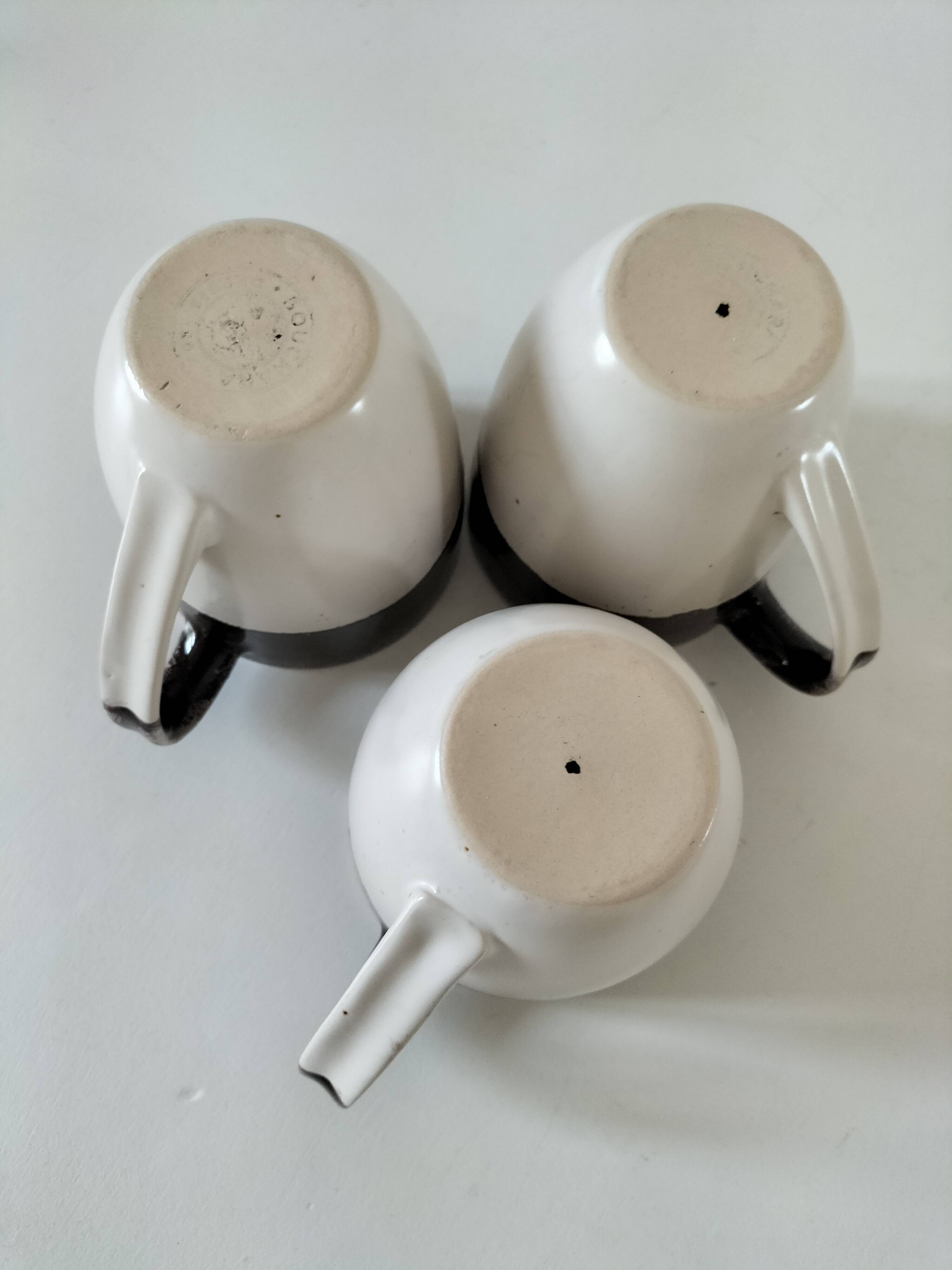 Set of three two-tone mugs, glazed stoneware, café workshop style.