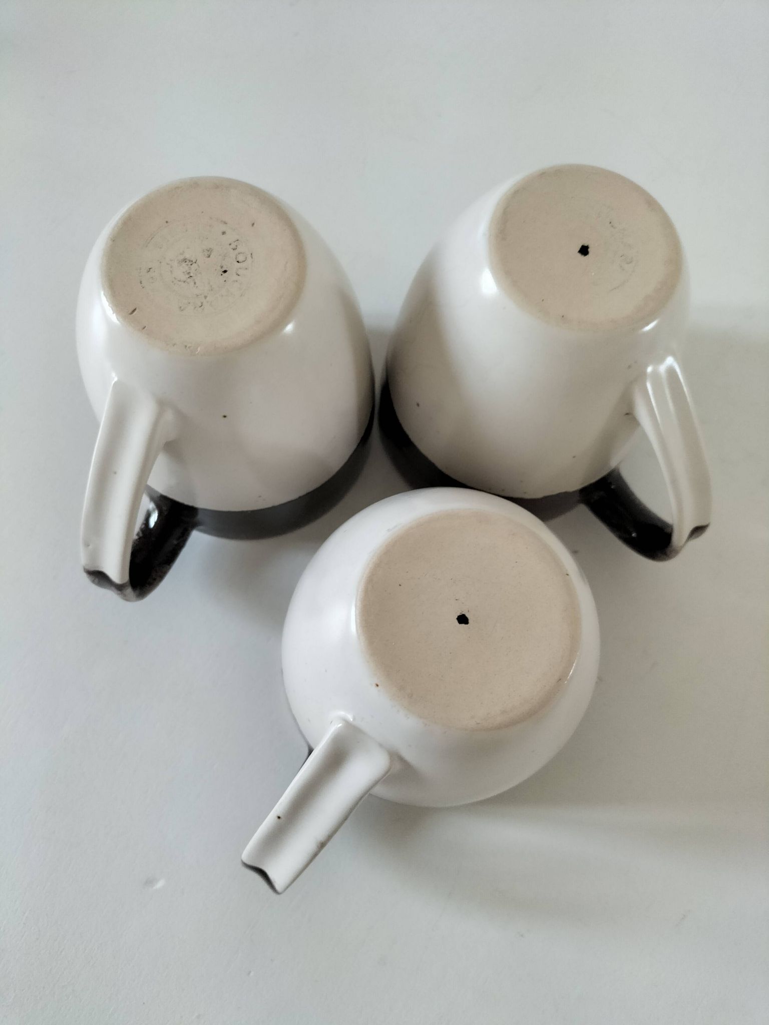 Set of three two-tone mugs, glazed stoneware, café workshop style.