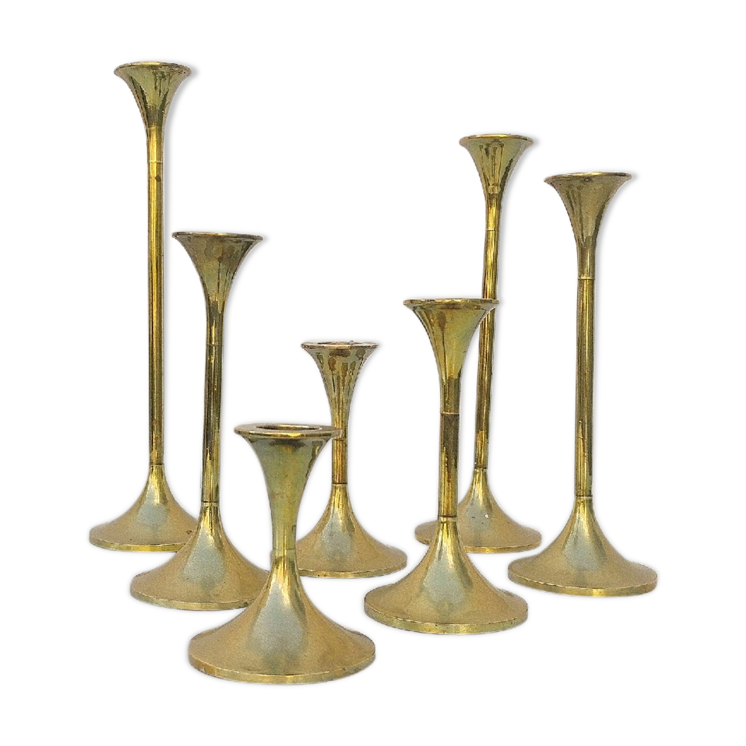 Seven candle holders in golden brass vintage trend