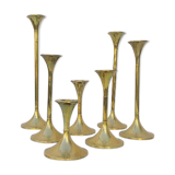 Seven candle holders in golden brass vintage trend