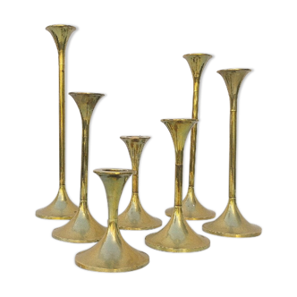 Seven candle holders in golden brass vintage trend