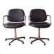 Pair of vintage swivel armchairs in metal and black faux leather.