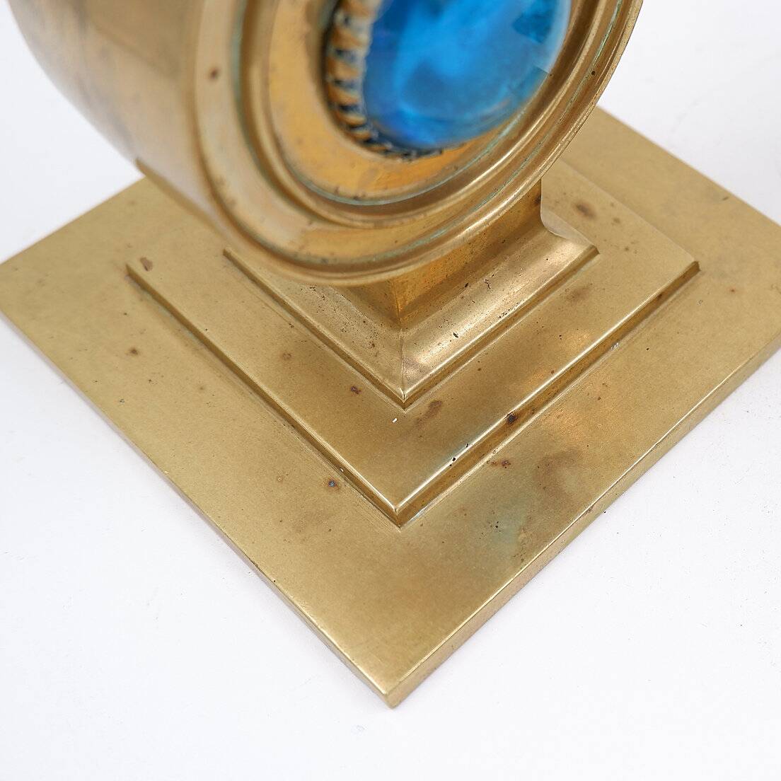 Pair of brass candlesticks decorated with a blue stone inlaid in the center