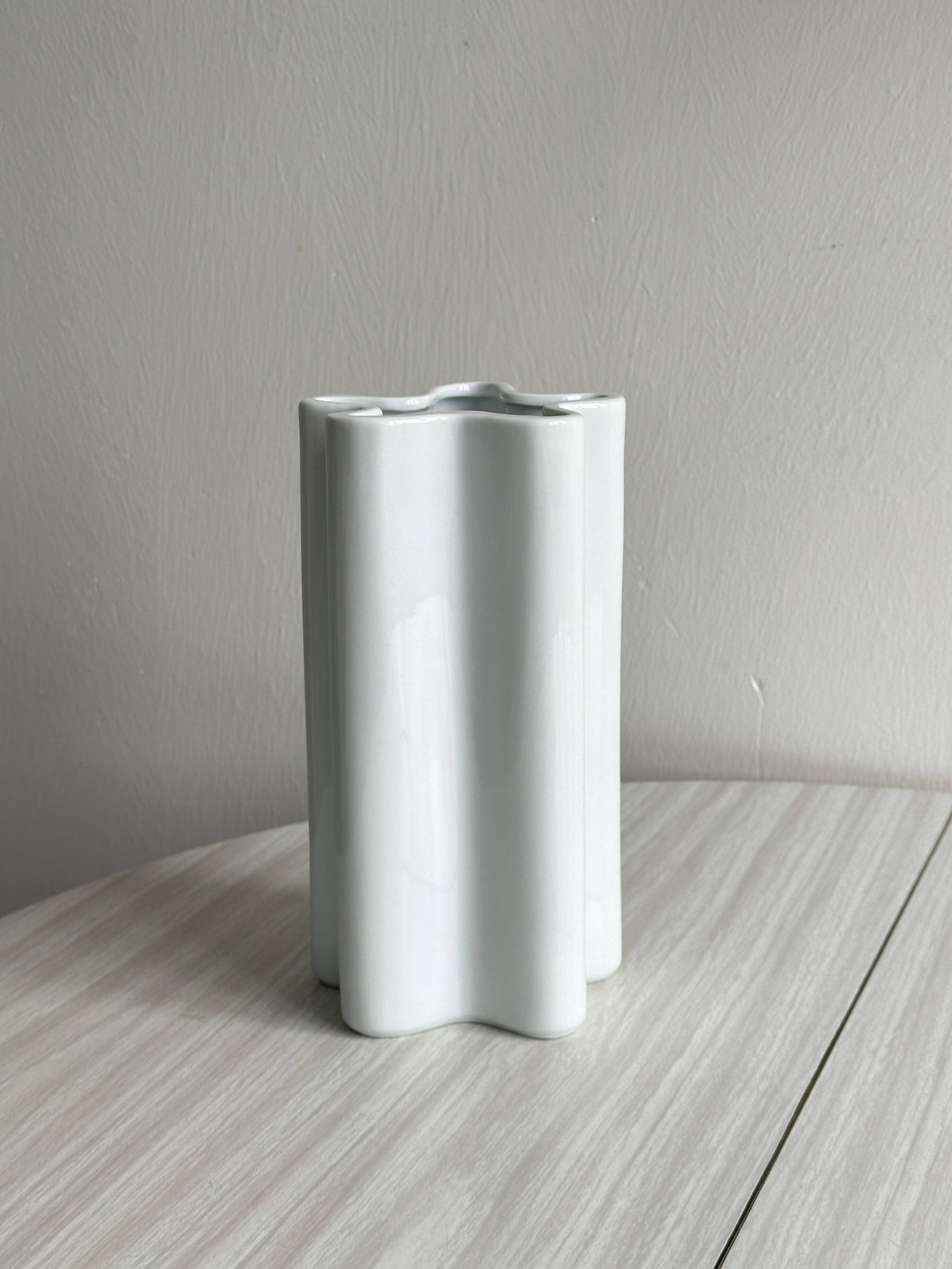Modern white ceramic vase with wavy curves
