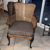 Chair with cane back and recently reupholstered fabric seat.