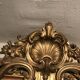 Large antique mirror with flagship shell in wood and gilded stucco