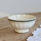 Old ivory ceramic bowl with double green trim.