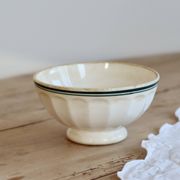 Old ivory ceramic bowl with double green trim.