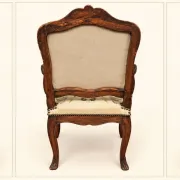 Louis XV cabriolet armchair, carved walnut, petit point tapestry, 18th century.