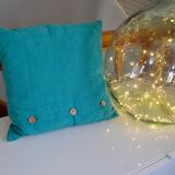 Scandinavian green cushion with wooden buttons
