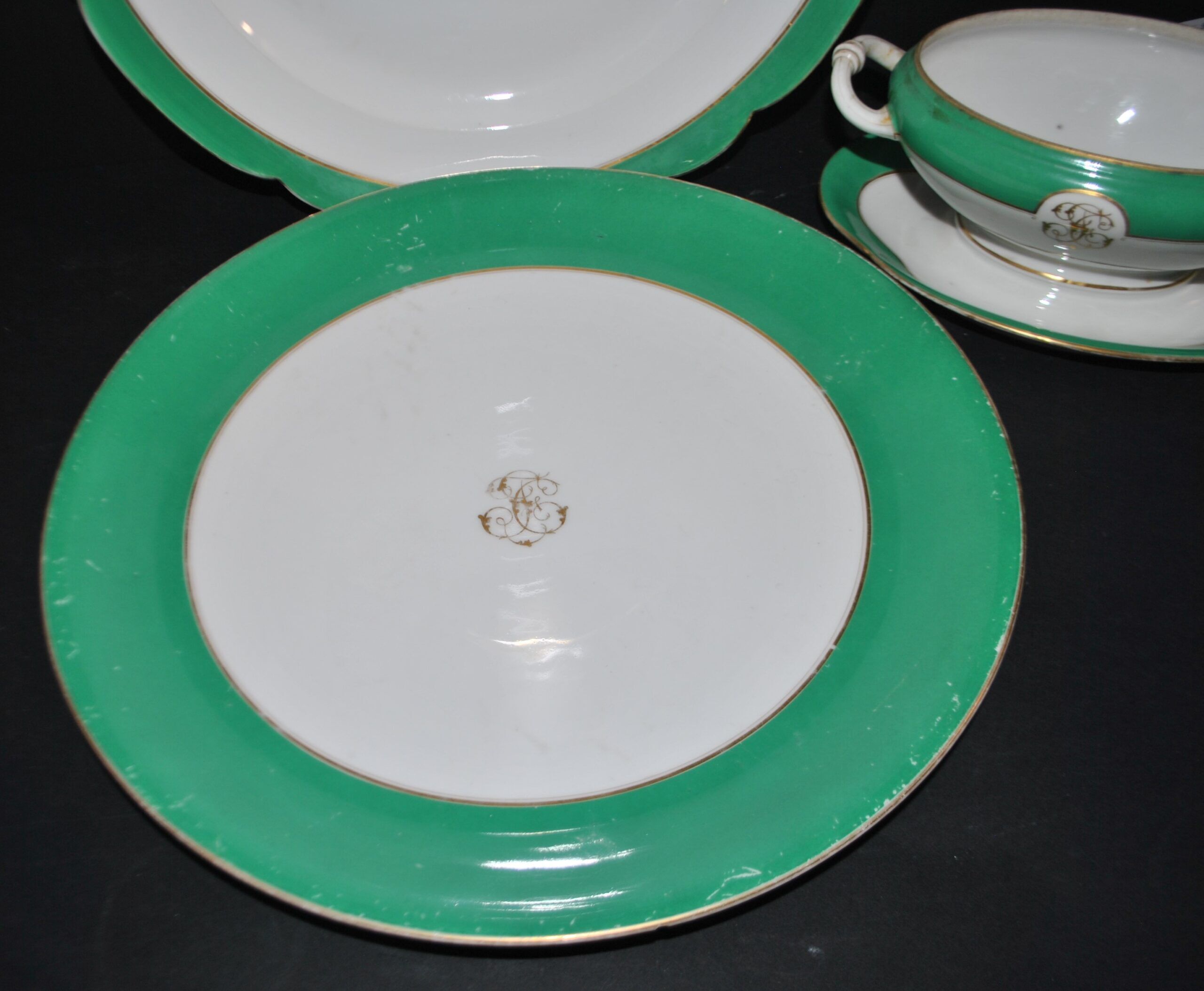 Paris porcelain set of 3 plates and a sauce boat with green border and gold monogram JC.