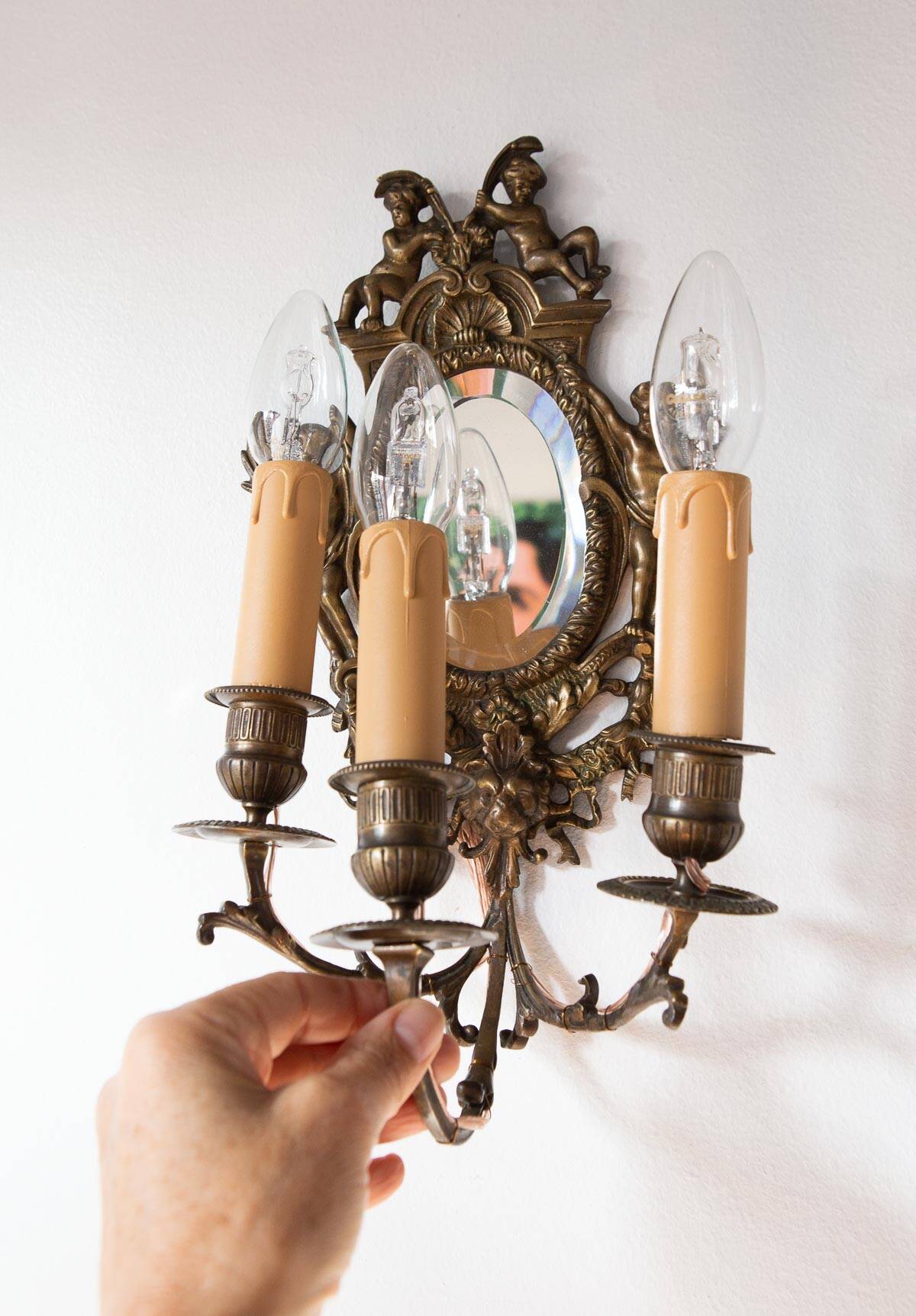Pair of old French wall lights with beveled mirror and putti