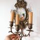 Pair of old French wall lights with beveled mirror and putti