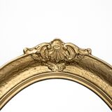 Oval mirror in a golden frame