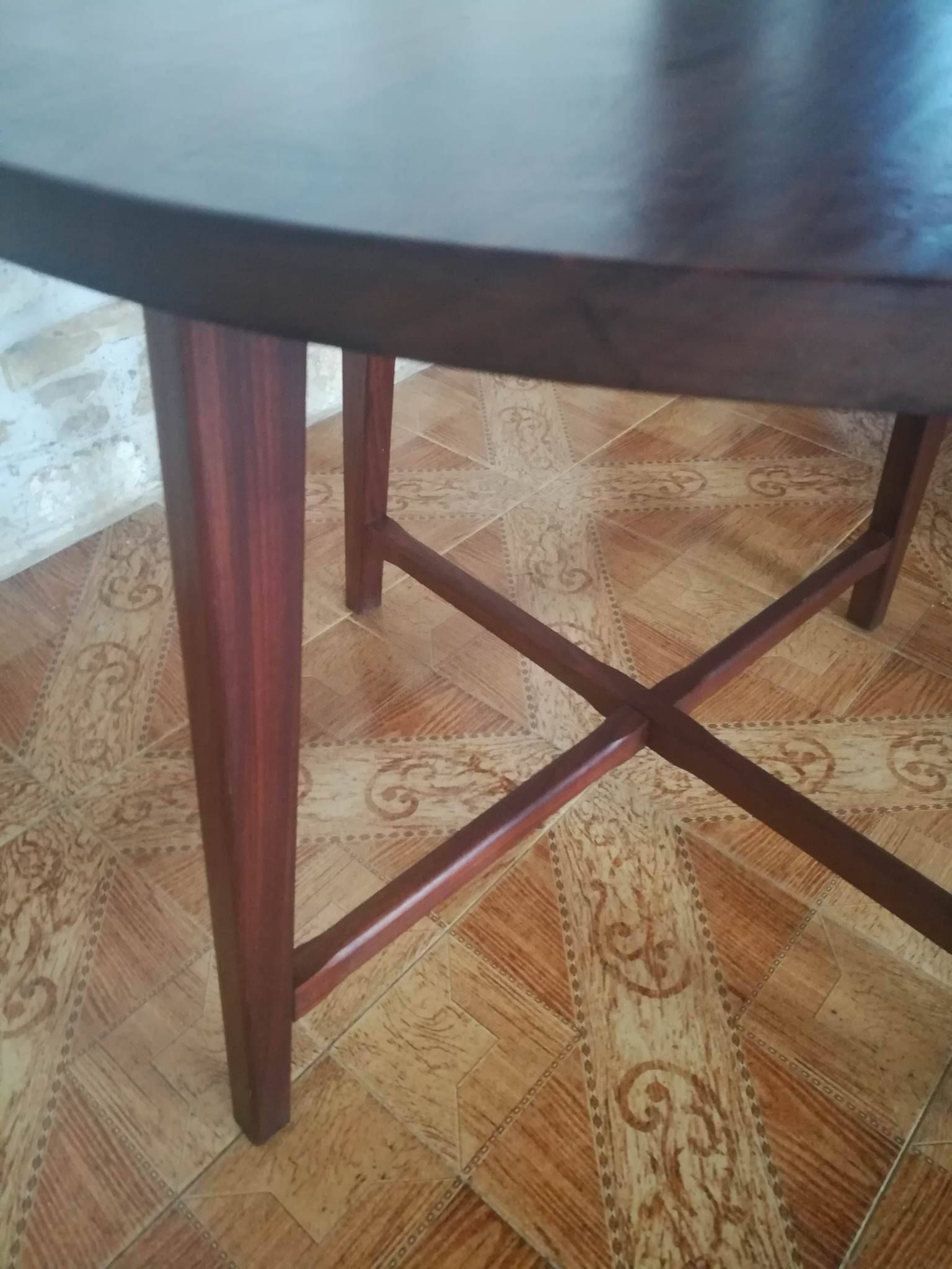 Round wooden table with thin legs