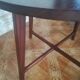 Round wooden table with thin legs