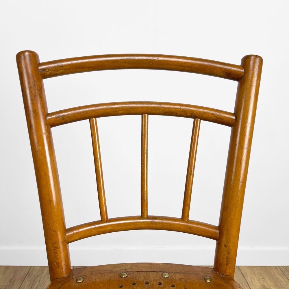 Pair of curved wood bistro chairs and studded and perforated seat