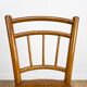 Pair of curved wood bistro chairs and studded and perforated seat