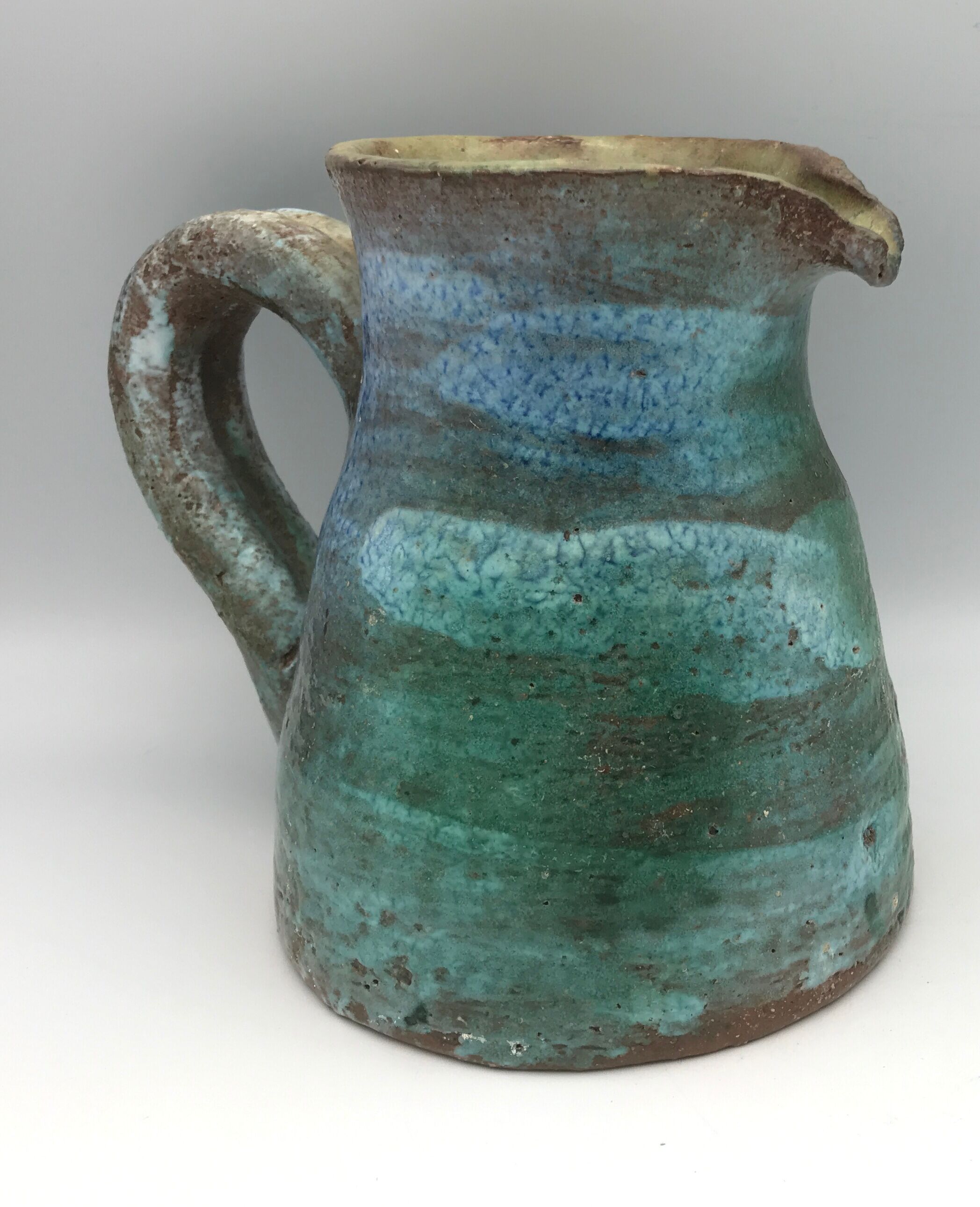 Vintage broc pitcher in enamelled sandstone with effect of blue shades, turquoise green signed