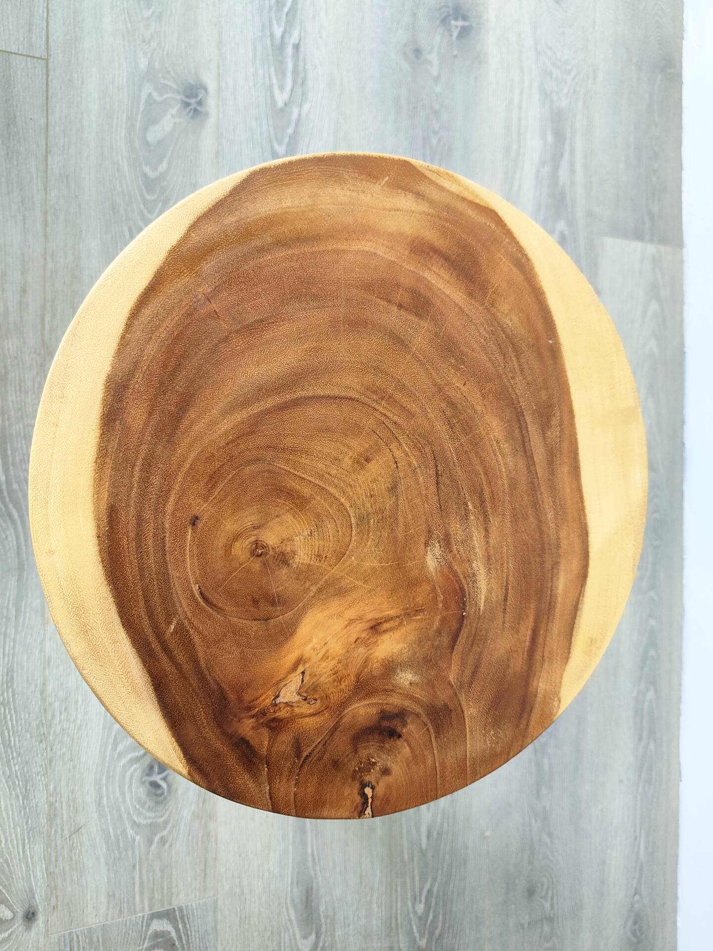 Minimalist side table in solid suar wood with conical legs.