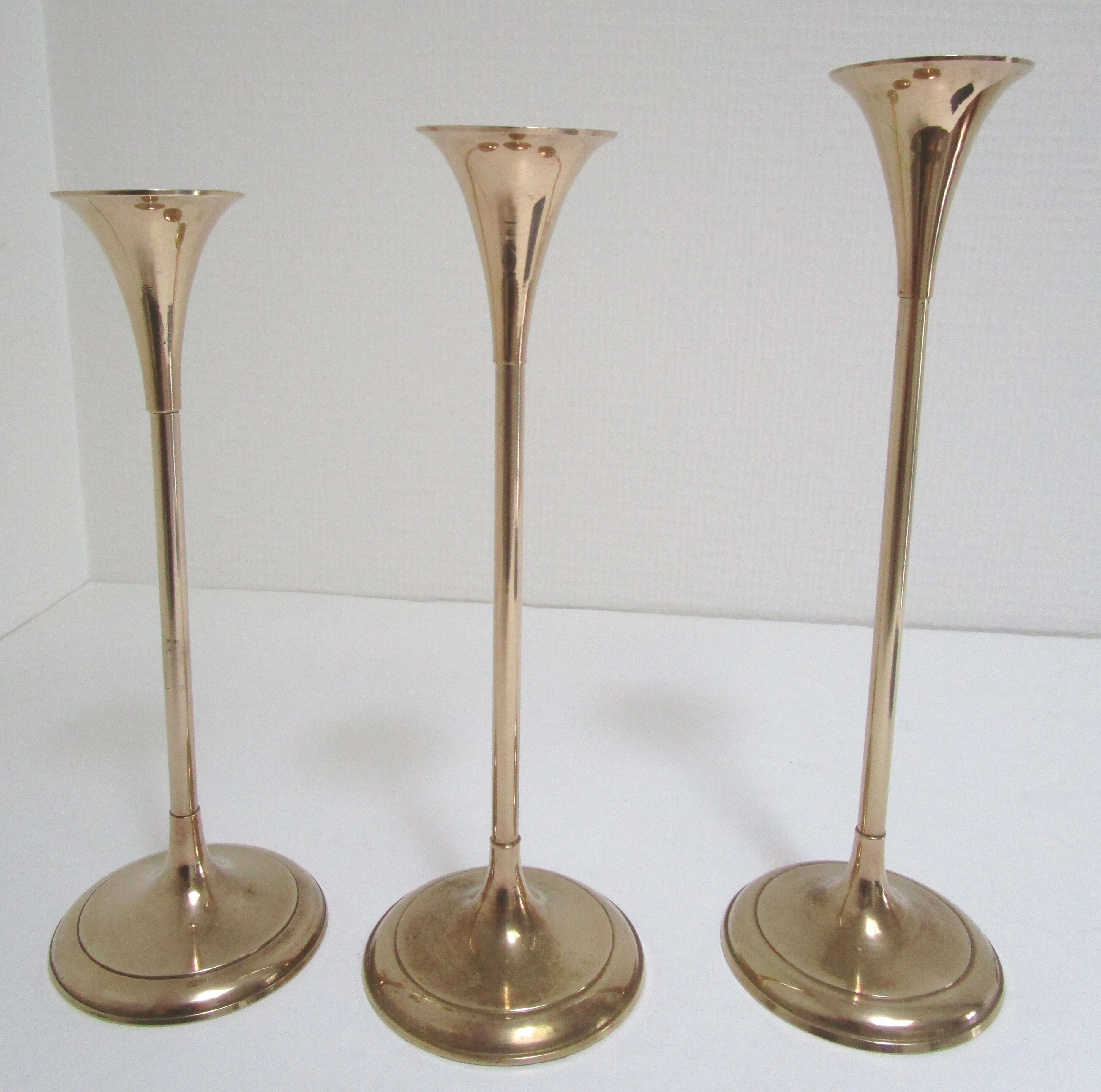 Trio of brass scandinavian candlesticks