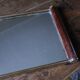 Rectangular mirror tray with wooden handles and gilding.