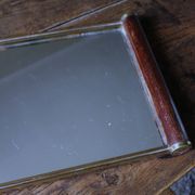 Rectangular mirror tray with wooden handles and gilding.