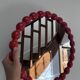 Round wall mirror with red beads in vintage retro design style.