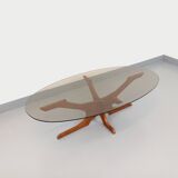 Vintage Hugues Poignant oval coffee table in teak and smoked glass from the 1970s