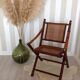 Fauteuil pliant en bambou, cannage, cuir et laiton