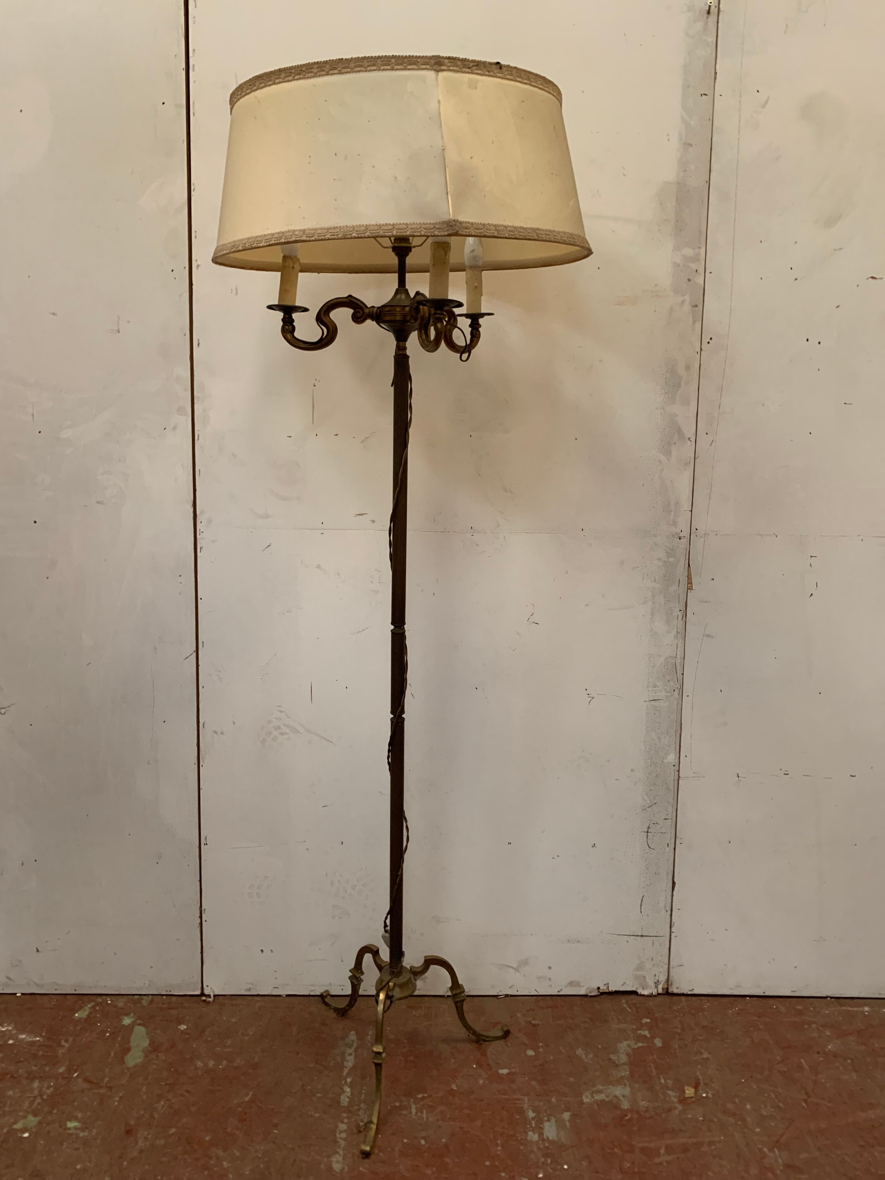 Floor lamp has three brass light arms