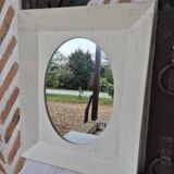 Oval mirror with a distressed white frame