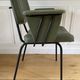 Vintage chair with green imitation leather armrests
