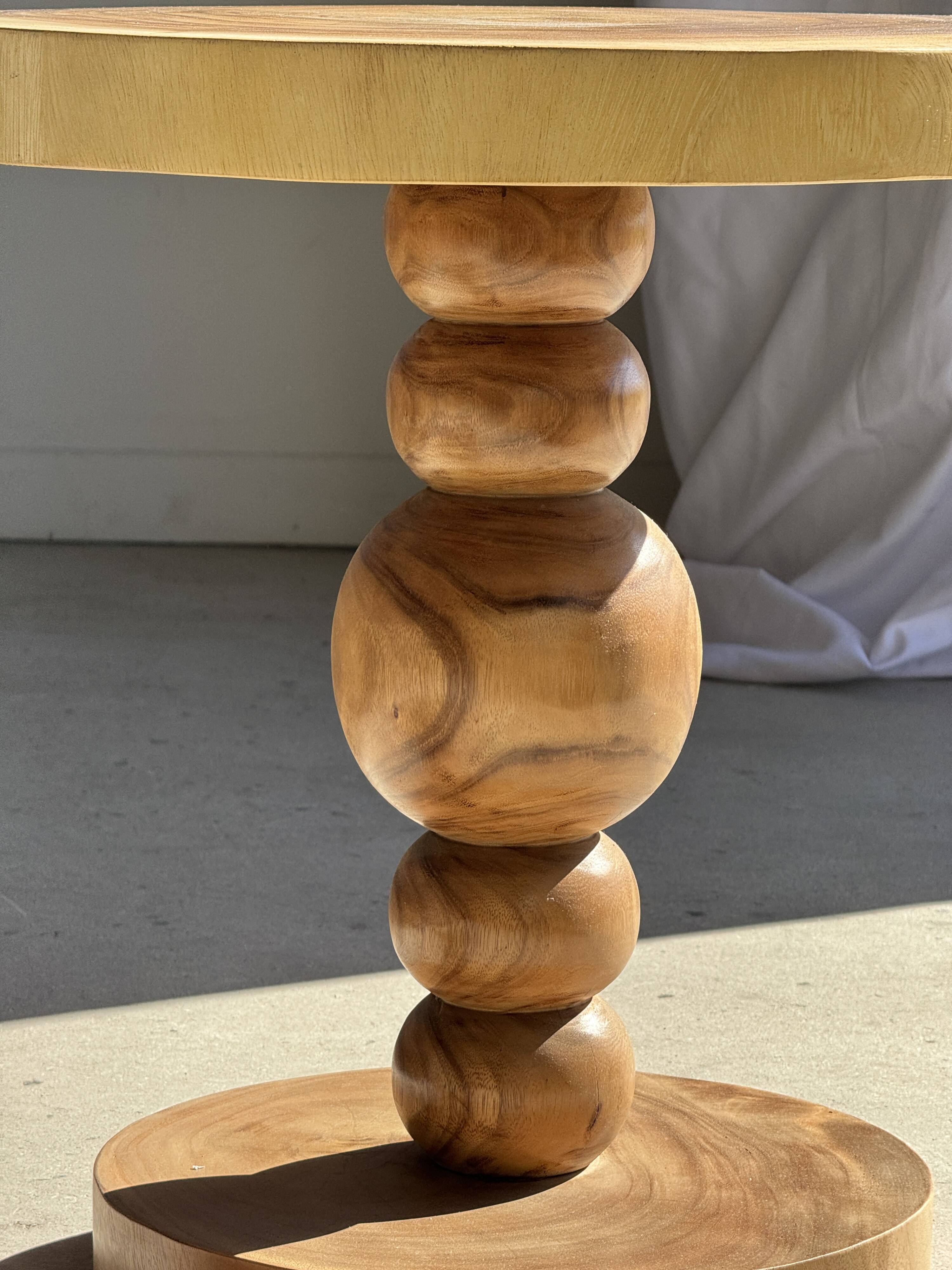 Coffee table in solid suar with central leg and spheres H56.5 D55.5