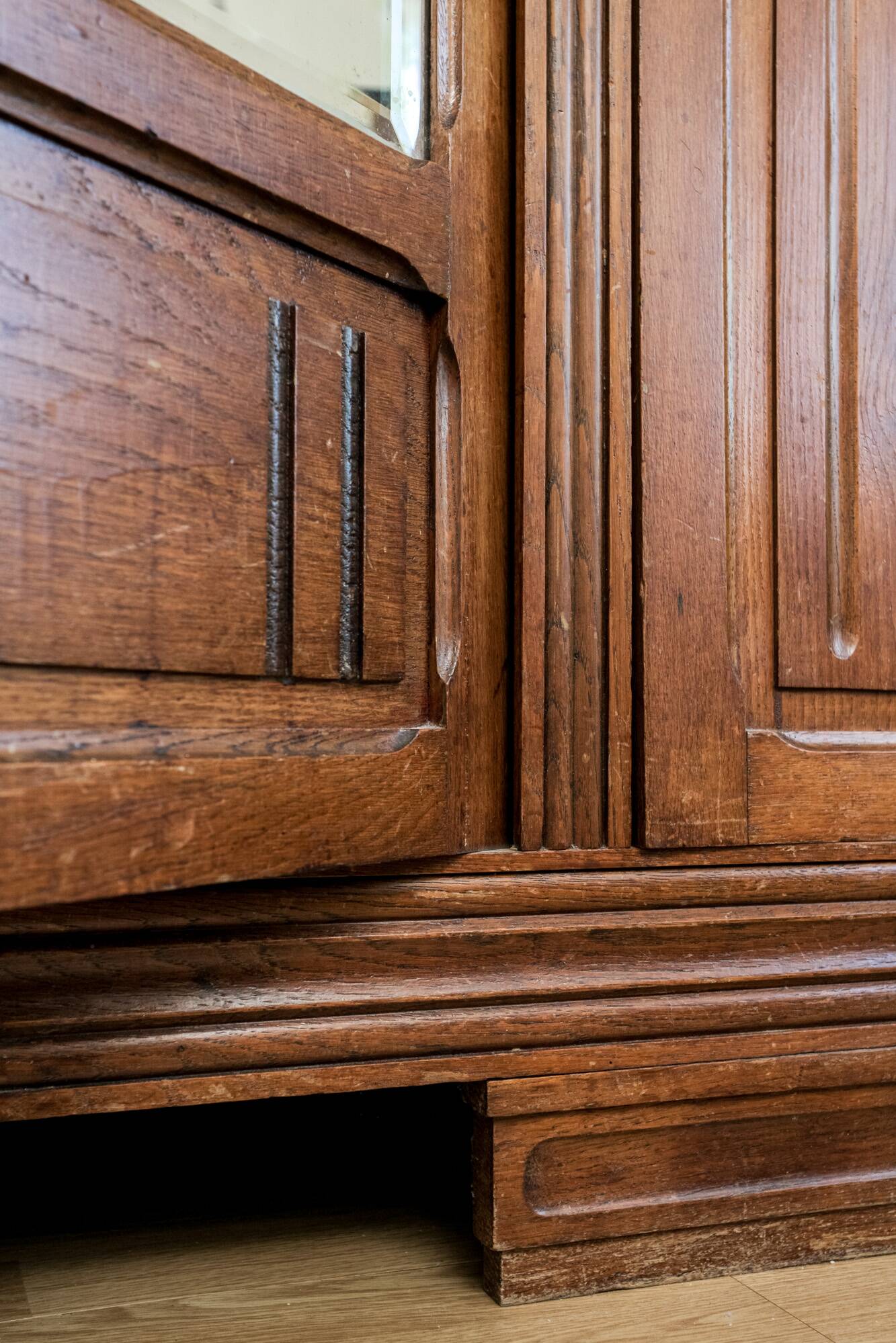 Old solid wood wardrobe with three vintage mirror doors
