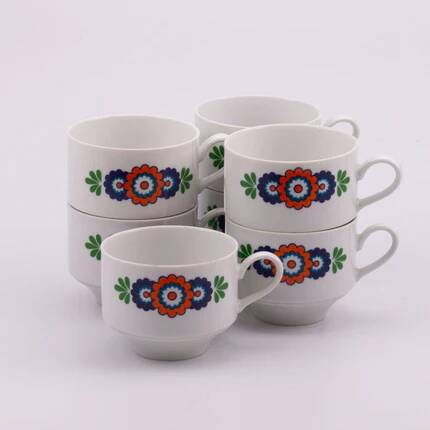 7 white porcelain cups from Winterling with coloured patterns.