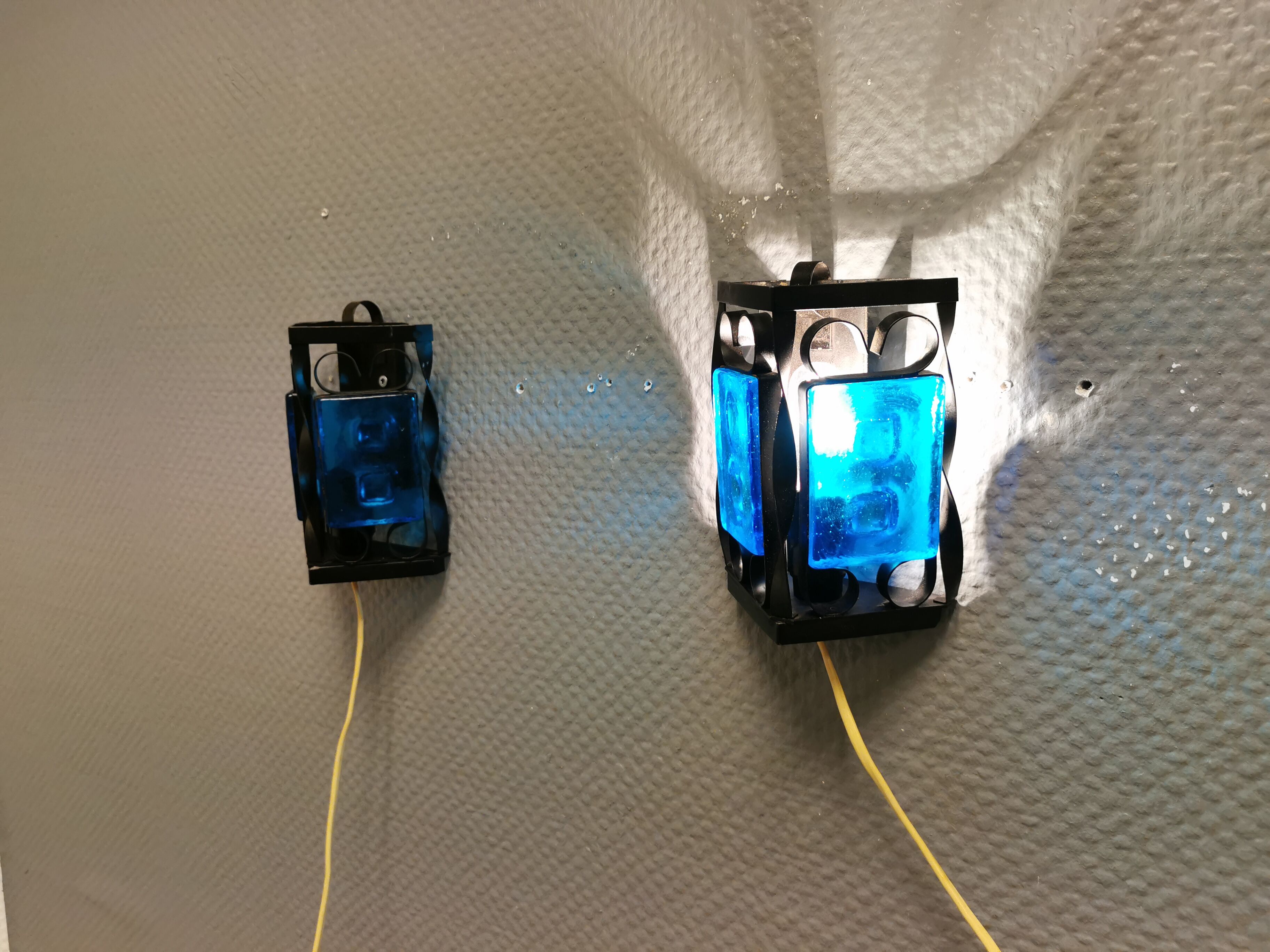 Wall lamps made of black cast iron and handmade thick pressed blue glass