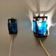 Wall lamps made of black cast iron and handmade thick pressed blue glass