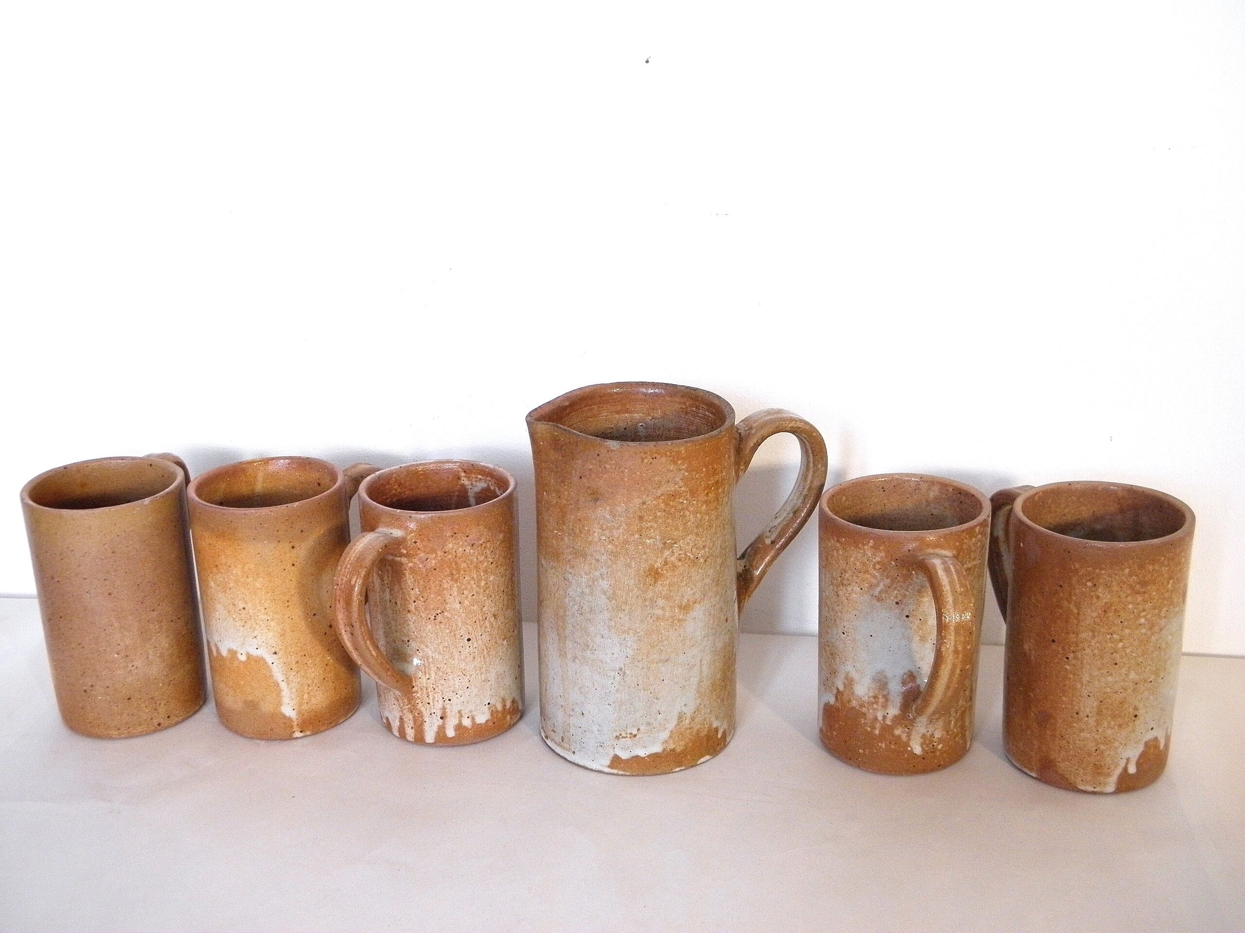 Decanter and enamelled stoneware mugs