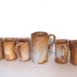 Decanter and enamelled stoneware mugs
