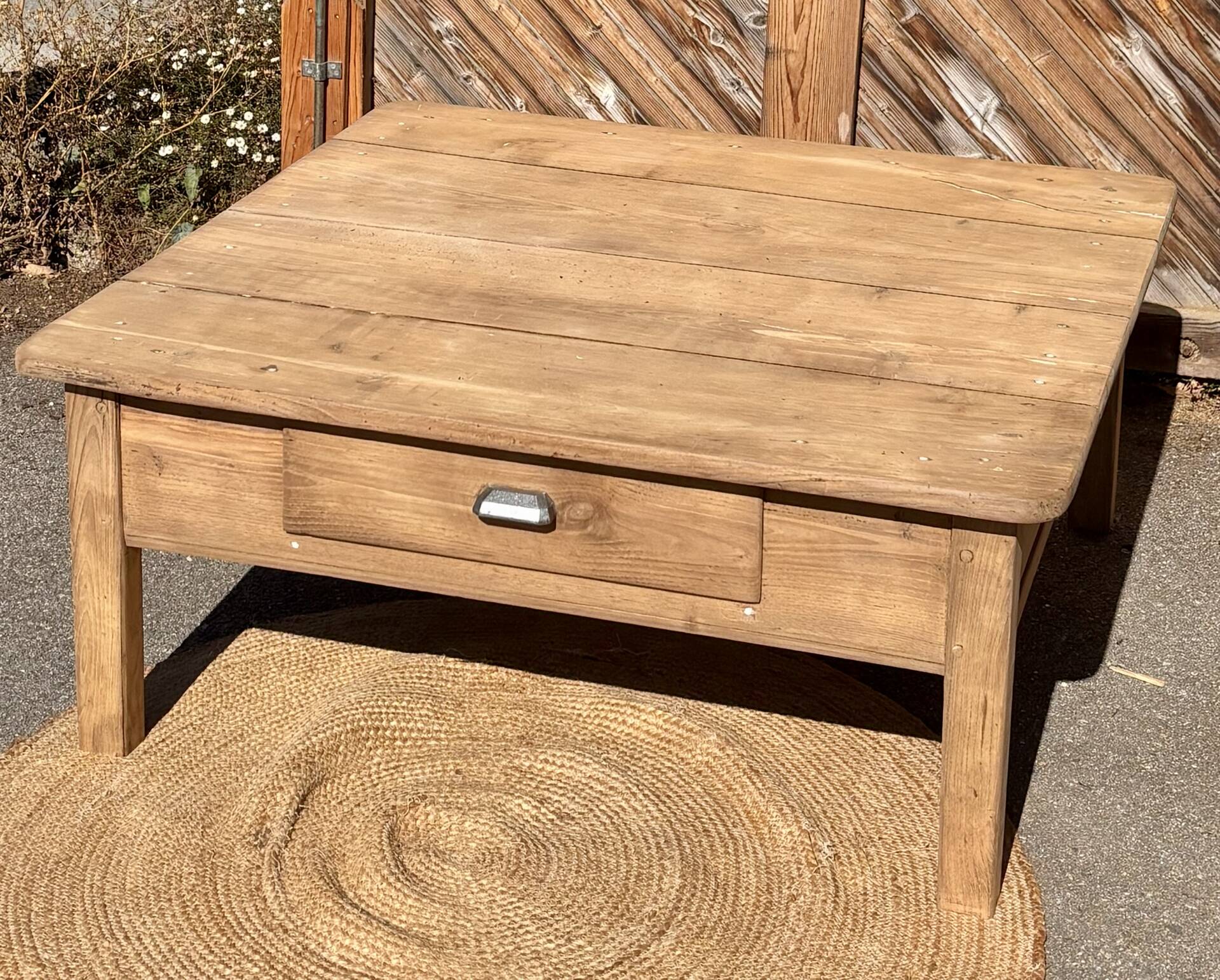 Large square farmhouse coffee table made of raw solid oak.