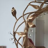 Round mirror in gilded wrought iron and leaves