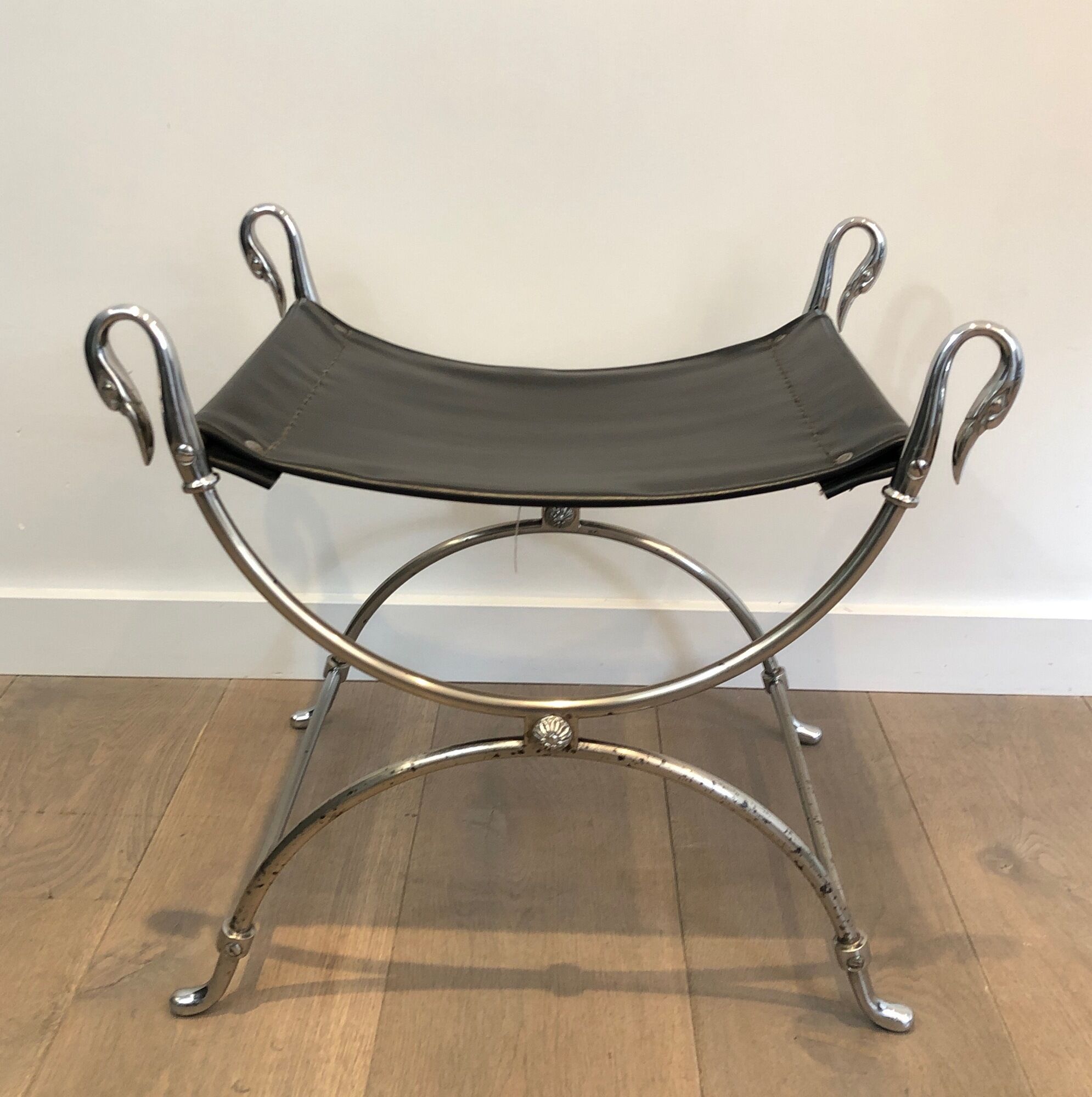 Curule stool in silver steel neoclassical style with swan heads