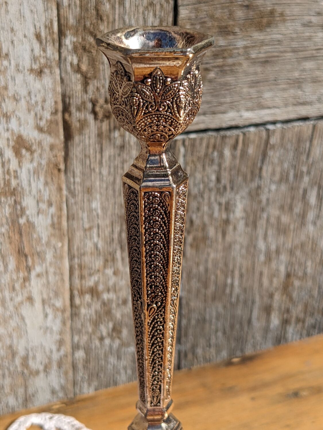 Pair of chiseled metal candle holders