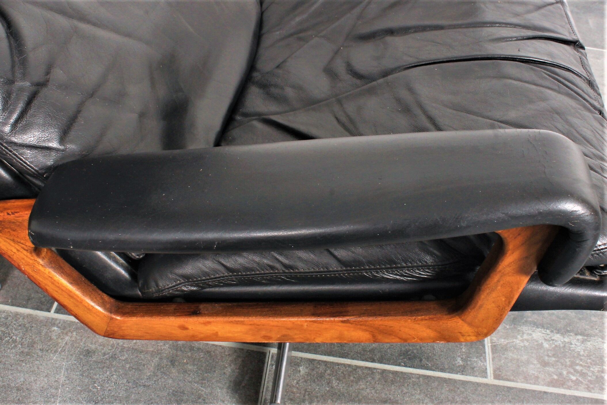 Armchair and footstool by André Vandenbeuck for Strässle in black leather