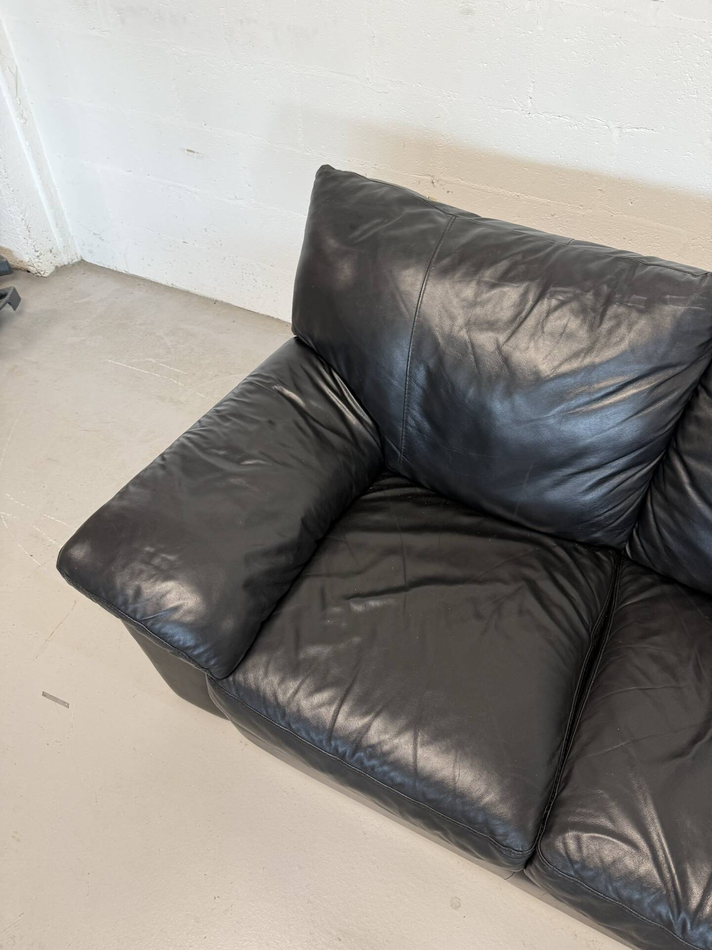Two-seater black leather sofa — postmodern design