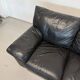 Two-seater black leather sofa — postmodern design