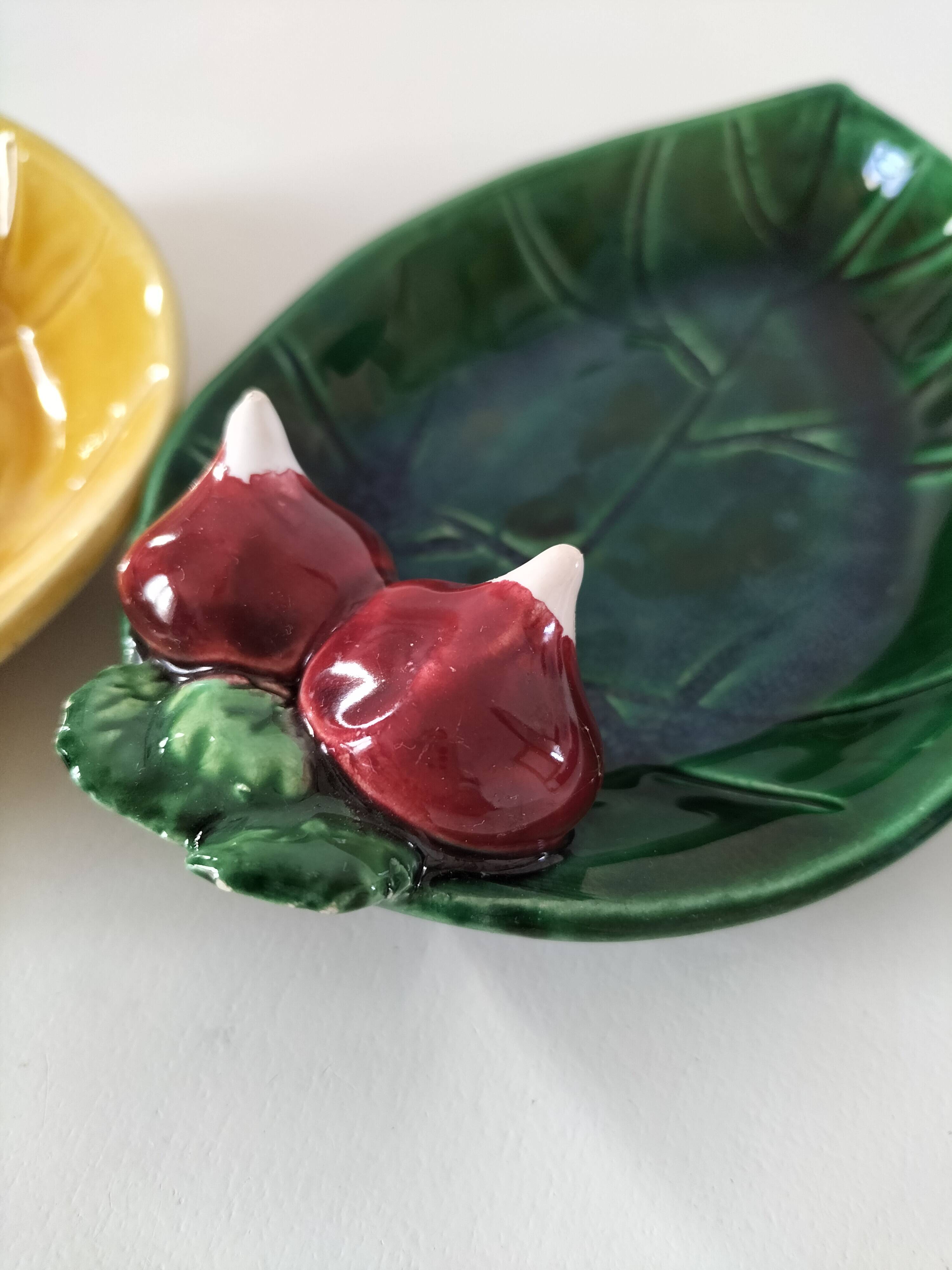 Two relief bowls with leaf designs, radishes, and tomatoes.