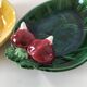 Two relief bowls with leaf designs, radishes, and tomatoes.