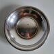 Shallow round metal plate with pearl row decoration.